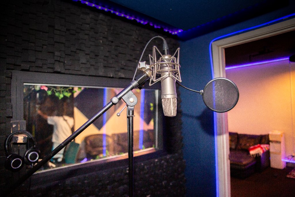 Microphone in the booth, window through to the control room