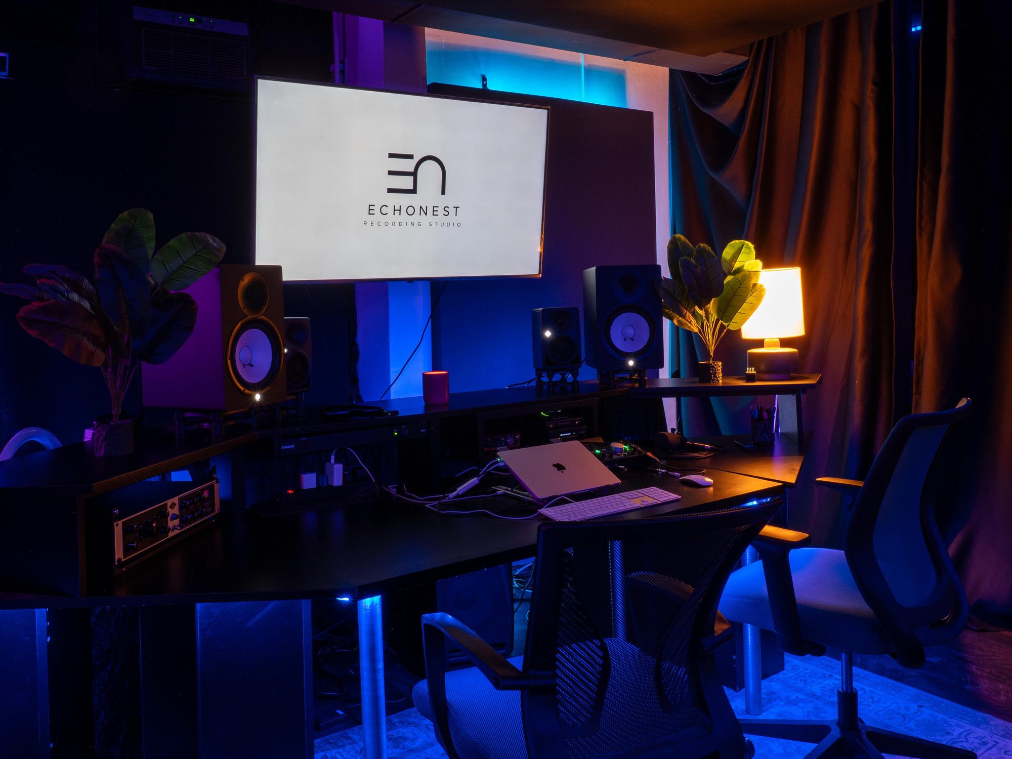 Studio desk with outboard gear, the projector screen showing the EchoNest logo