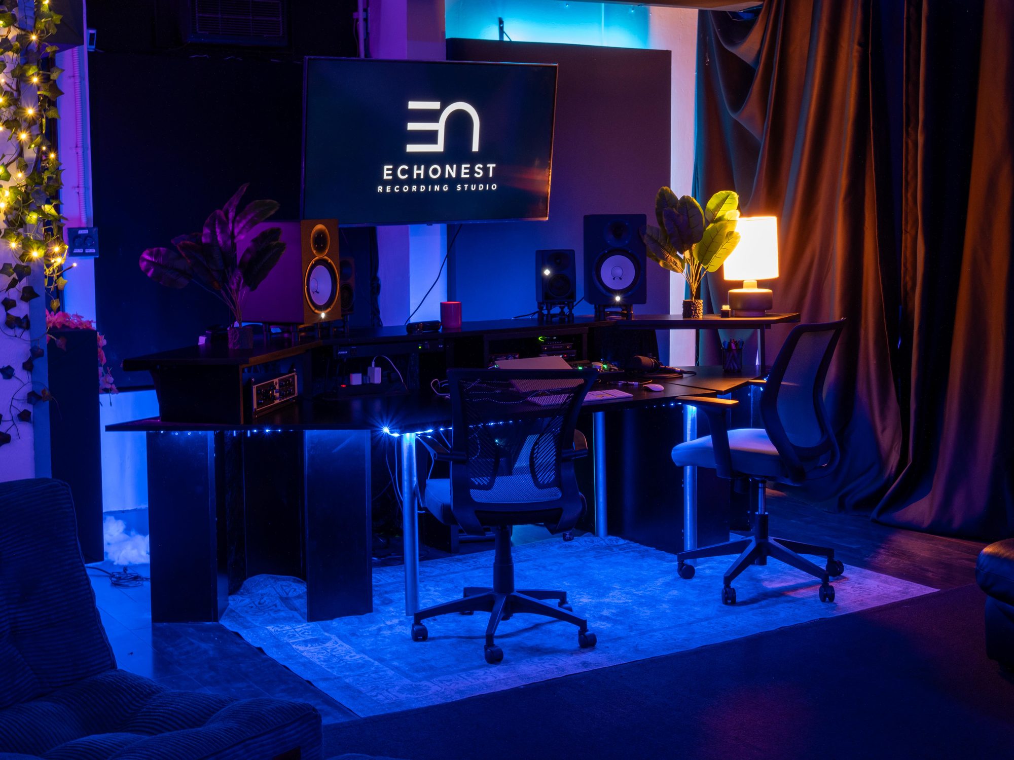 The mixing desk and monitors beneath the projector screen